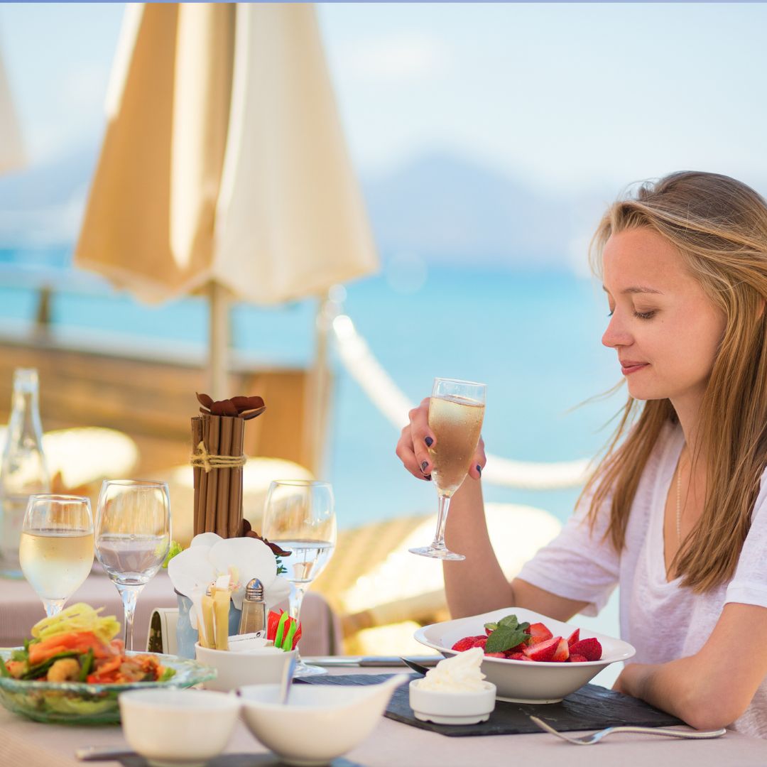 Woman choosing a balanced restaurant meal on holiday to support PMOS and blood sugar balance.